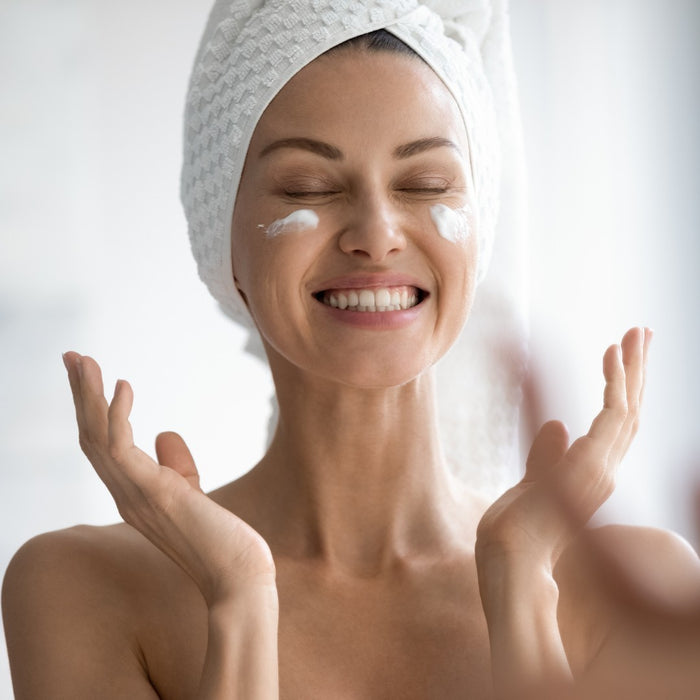  A woman applying an anti wrinkle cream to her face, showing how it can help to improve the appearance of wrinkles and fine lines.